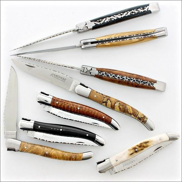 several Laguiole Traditional 12 cm Guilloche pocket knives on a white background