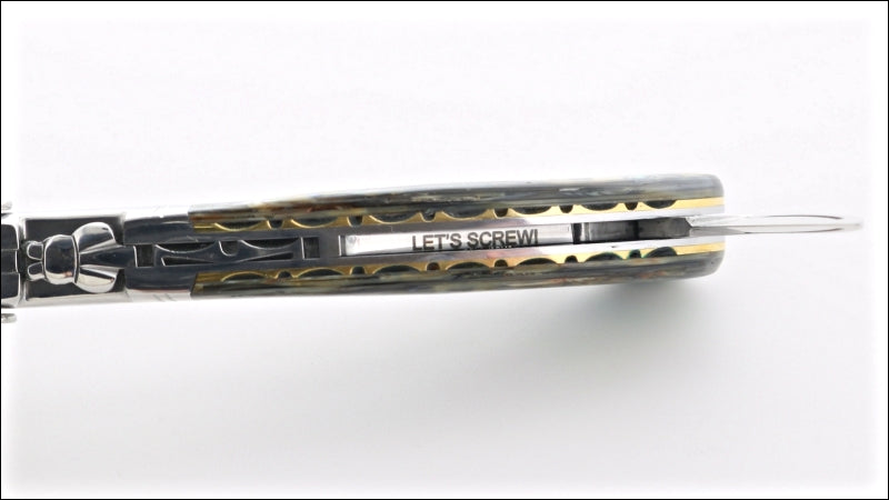 showing a laguiole magnum with "let's screw!' engraving inside the handle