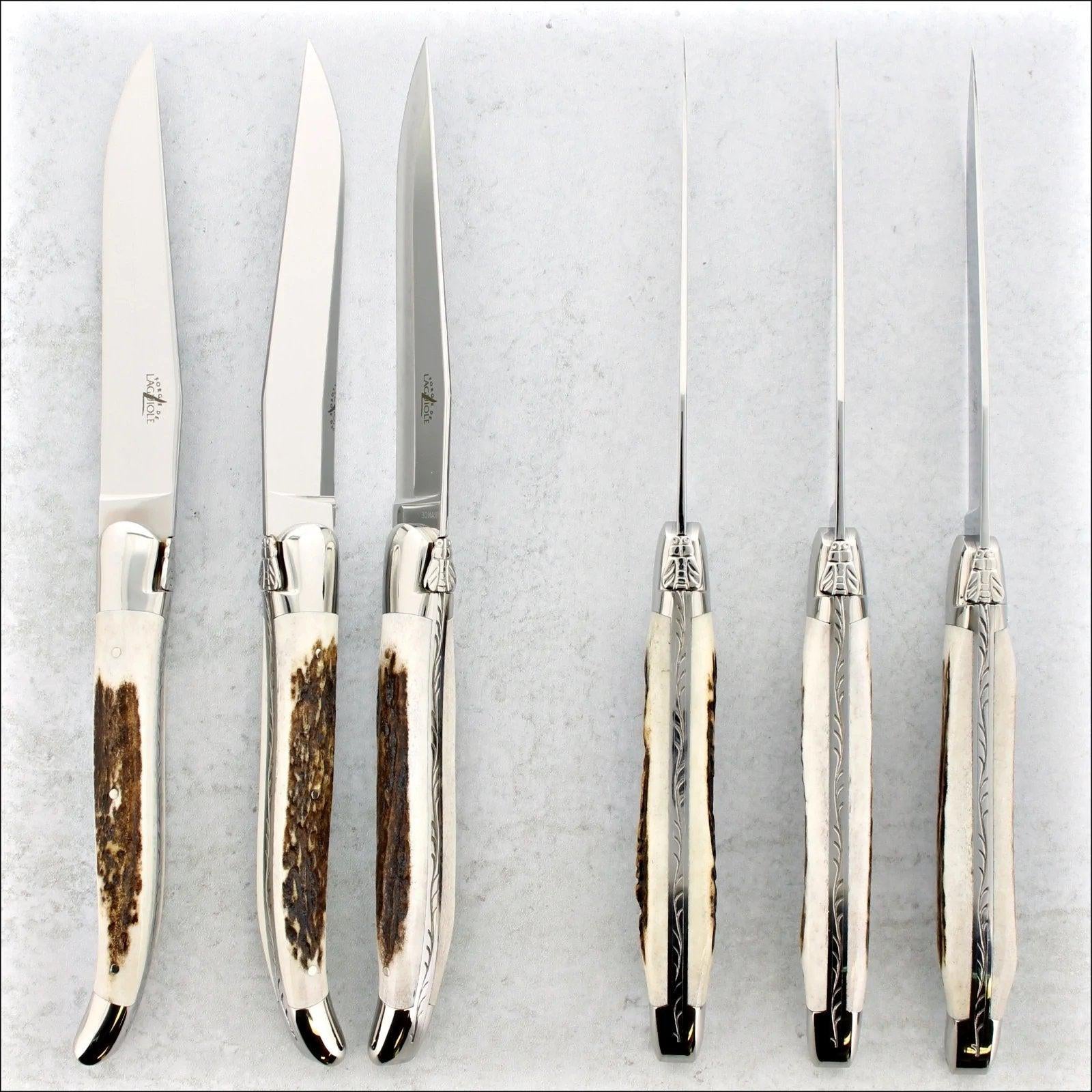 A SET OF FORGE DE LAGUIOLE STEAK KNIVES WITH DEER STAG HANDLES