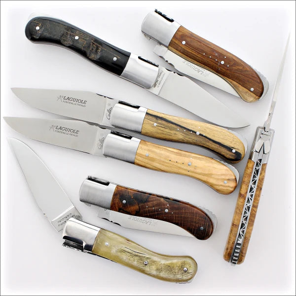 several Laguiole Gentleman classic folding knives on a white background