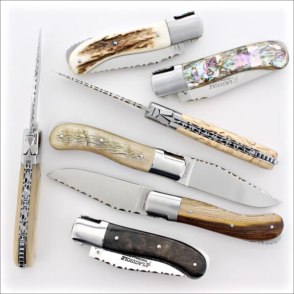 several Laguiole Gentleman Guilloche Series folding knives on a white background