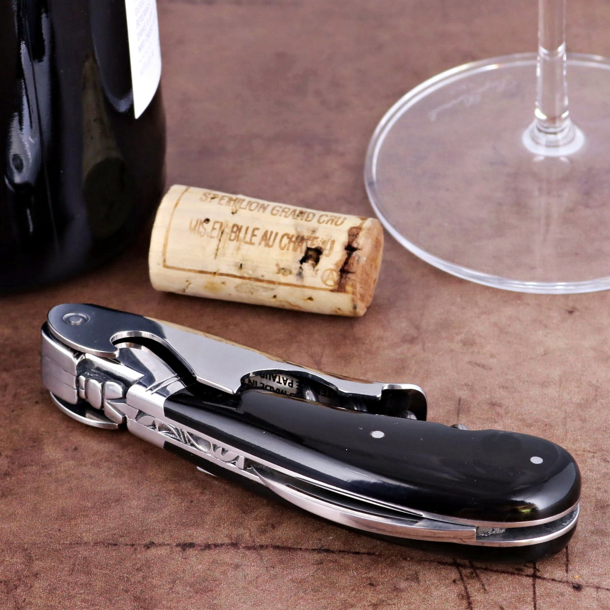 Laguiole Magnum Black Horn Tip Corkscrew, close-up of shiny black handle and silver mechanism.