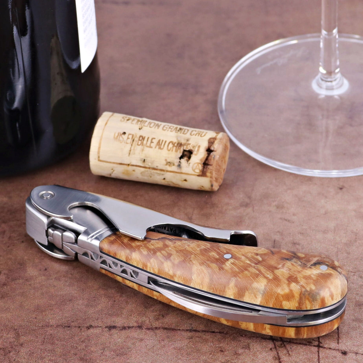 Laguiole Magnum Burled Beech Corkscrew, close-up of its natural wood handle and polished steel.