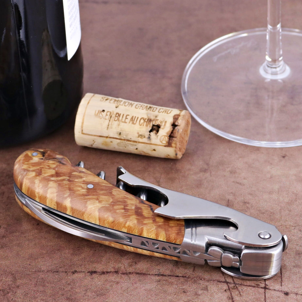 Laguiole Magnum Burled Beech Corkscrew, close-up of natural wood handle and silver metal.