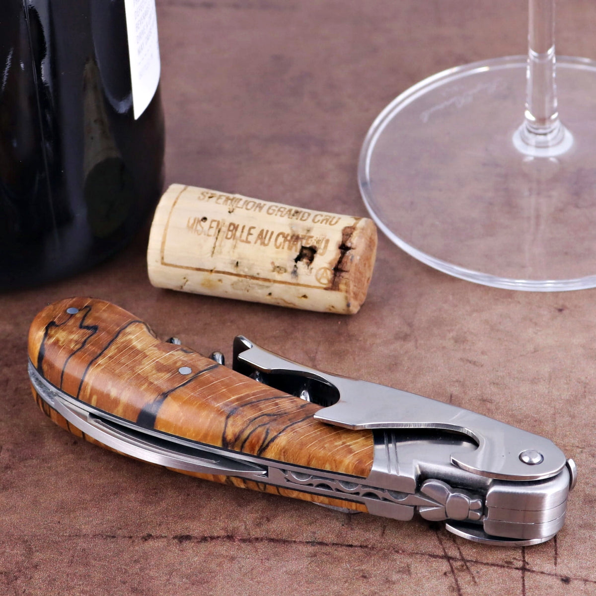 Laguiole Magnum Burled Beech End Grain Corkscrew, close-up of the elegant wood handle and stainless steel tools.