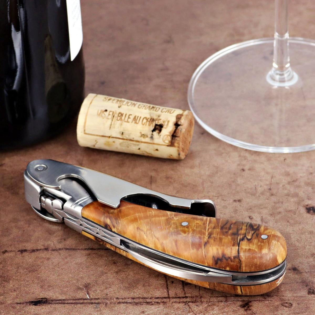Laguiole Magnum Burled Beech End Grain Corkscrew, close-up of its natural wood handle and polished metal.
