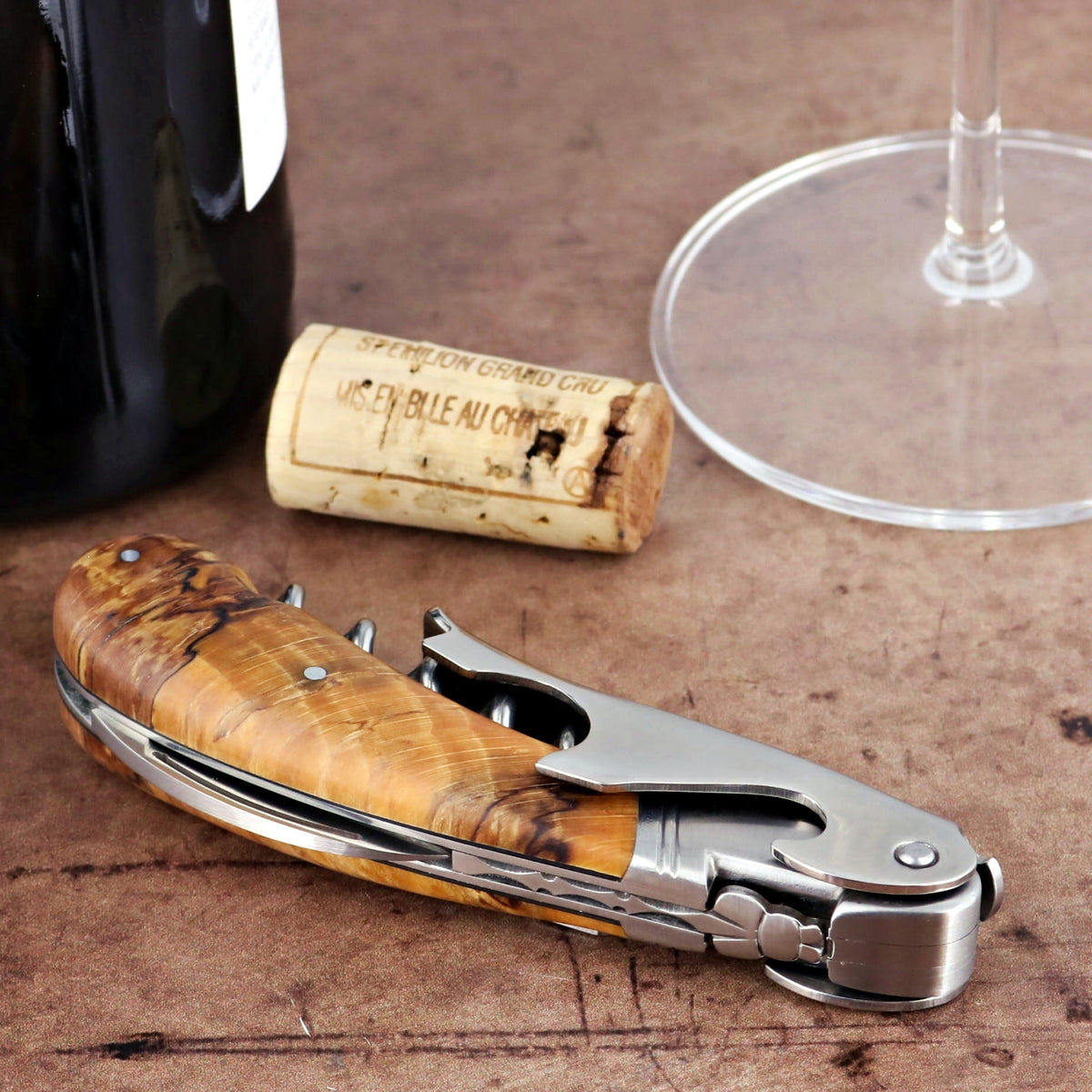 Laguiole Magnum Burled Beech End Grain Corkscrew, close-up of light wood handle and silver metal.