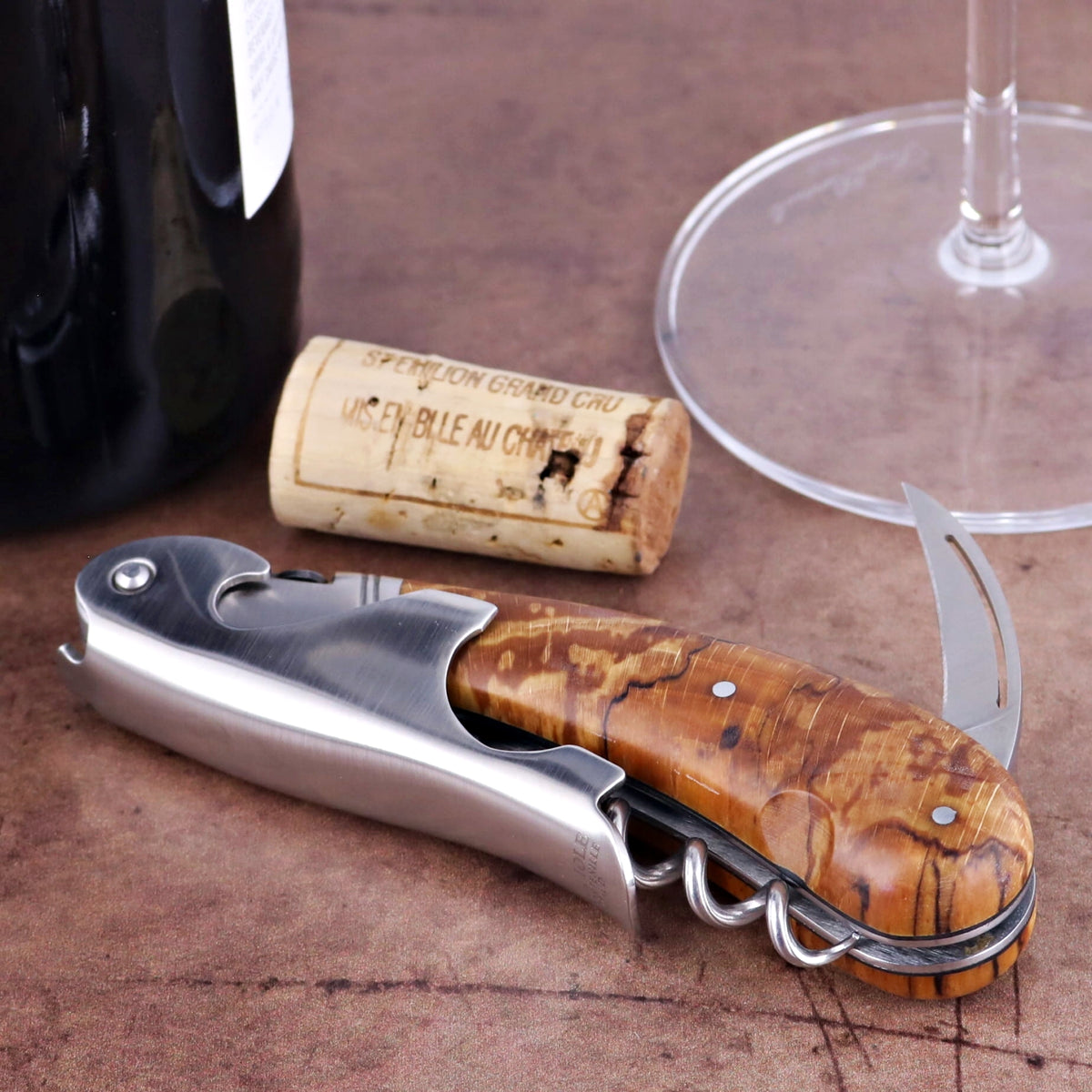 Laguiole Magnum Burled Beech End Grain Corkscrew, close-up of light brown wood handle and silver tools.