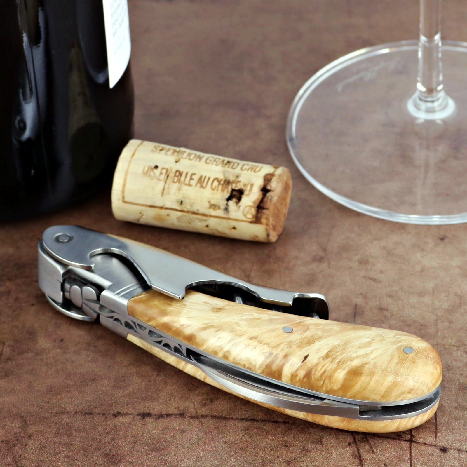 Laguiole Magnum Burled Maple Corkscrew, close-up of light wood handle, stainless steel, and foil cutter.
