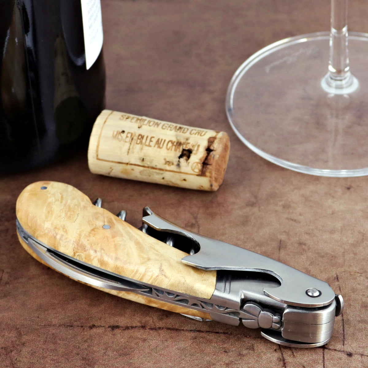 Laguiole Magnum Burled Maple Corkscrew, close-up of light wood handle with stainless steel tools.