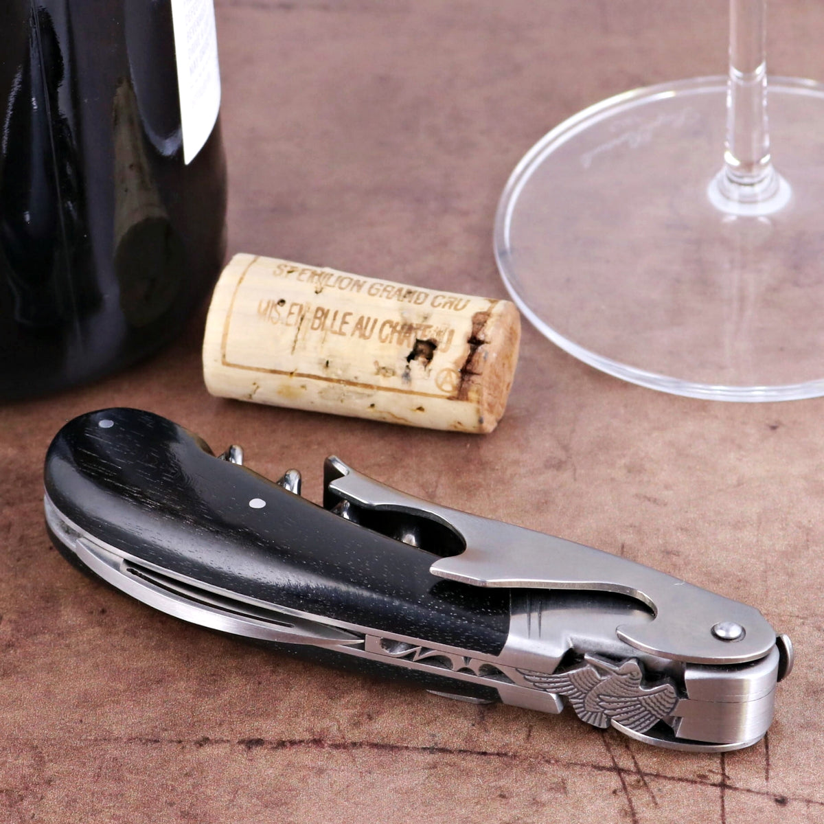 Laguiole Magnum Ebony Corkscrew, close-up of folded black ebony handle with silver metal details.
