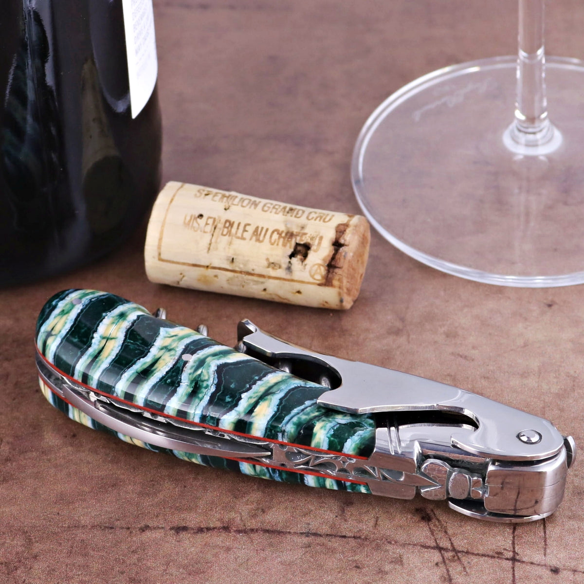 Laguiole Magnum Guilloche Mammoth Tooth - Rain Forest, close-up of green and white handle corkscrew.