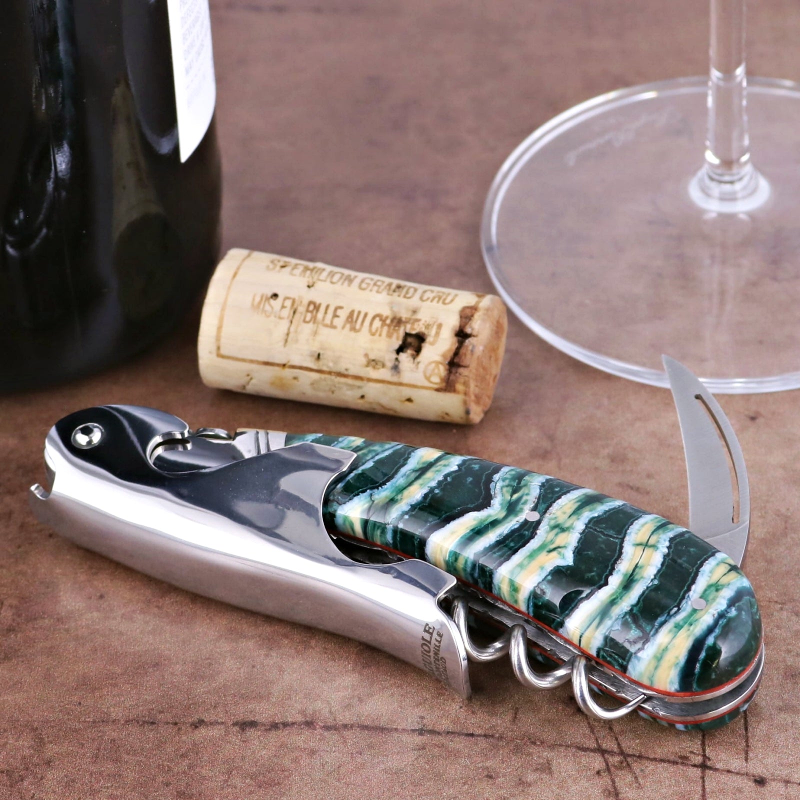 Laguiole Magnum Guilloche Mammoth Tooth - Rain Forest corkscrew, close-up of green and white patterned handle.