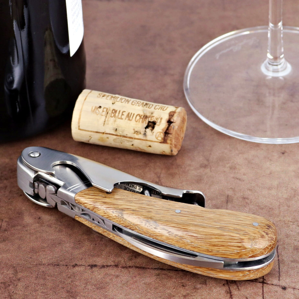 Laguiole Magnum Oak Barrel Wood Corkscrew, close-up of the oak handle and polished steel.