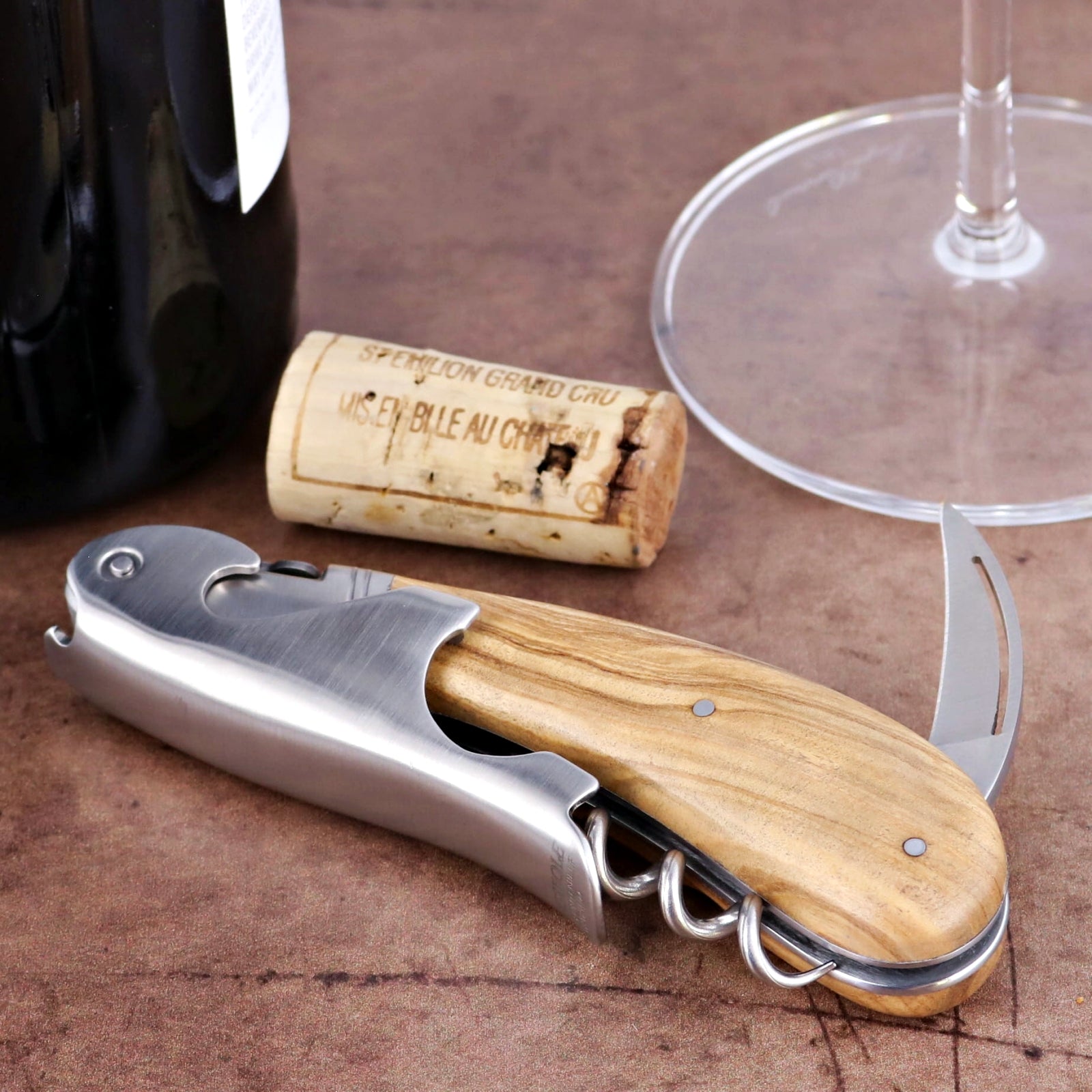 Laguiole Magnum Olive Wood Corkscrew, close-up of the natural wood handle and stainless steel tools.