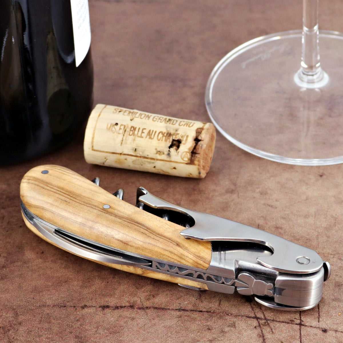 Laguiole Magnum Olive Wood Corkscrew, close-up of natural wood handle and polished steel.