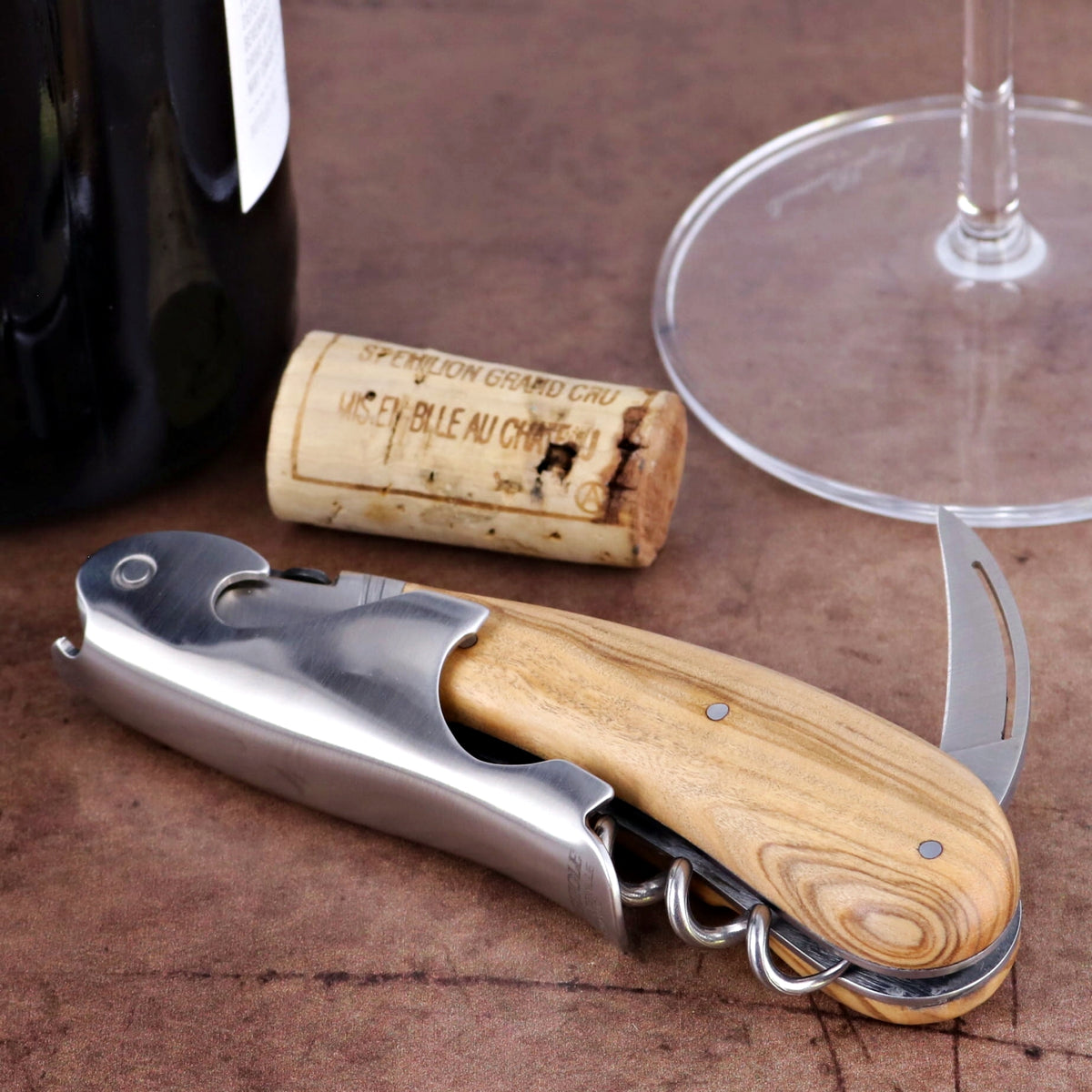 Laguiole Magnum Olive Wood Corkscrew, close-up of the olive wood handle and polished steel body.