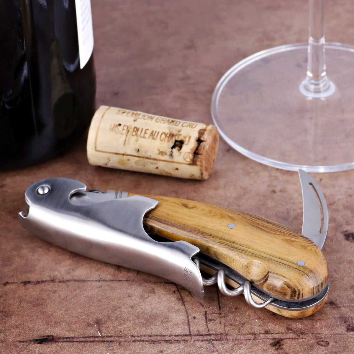 Laguiole Magnum Pistachio Corkscrew, close-up of wood handle, stainless steel body, and foil cutter.