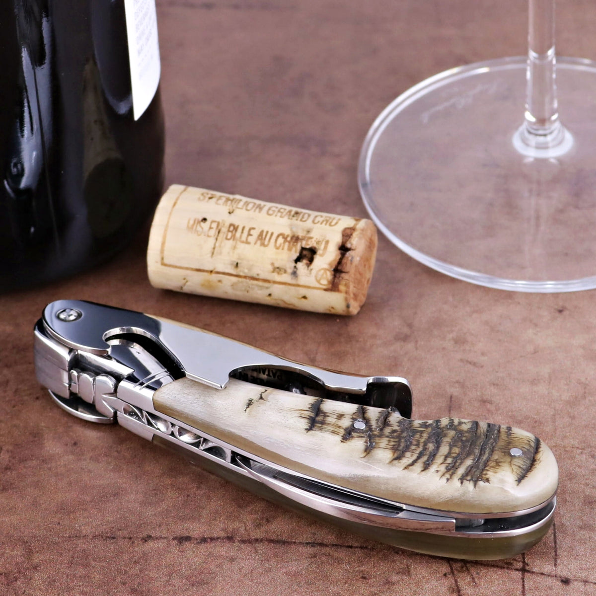 Laguiole Magnum Ram Horn Corkscrew - H, close-up of ram horn handle with stainless steel.