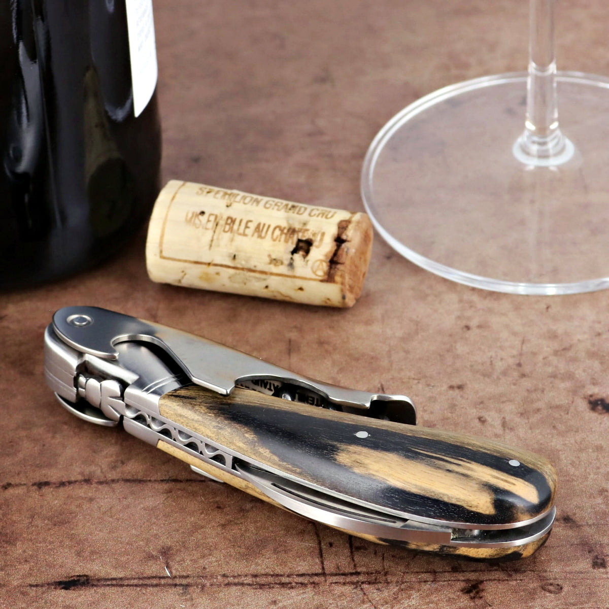 Laguiole Magnum Royal Ebony Corkscrew, close-up of dark wood handle with light streaks.