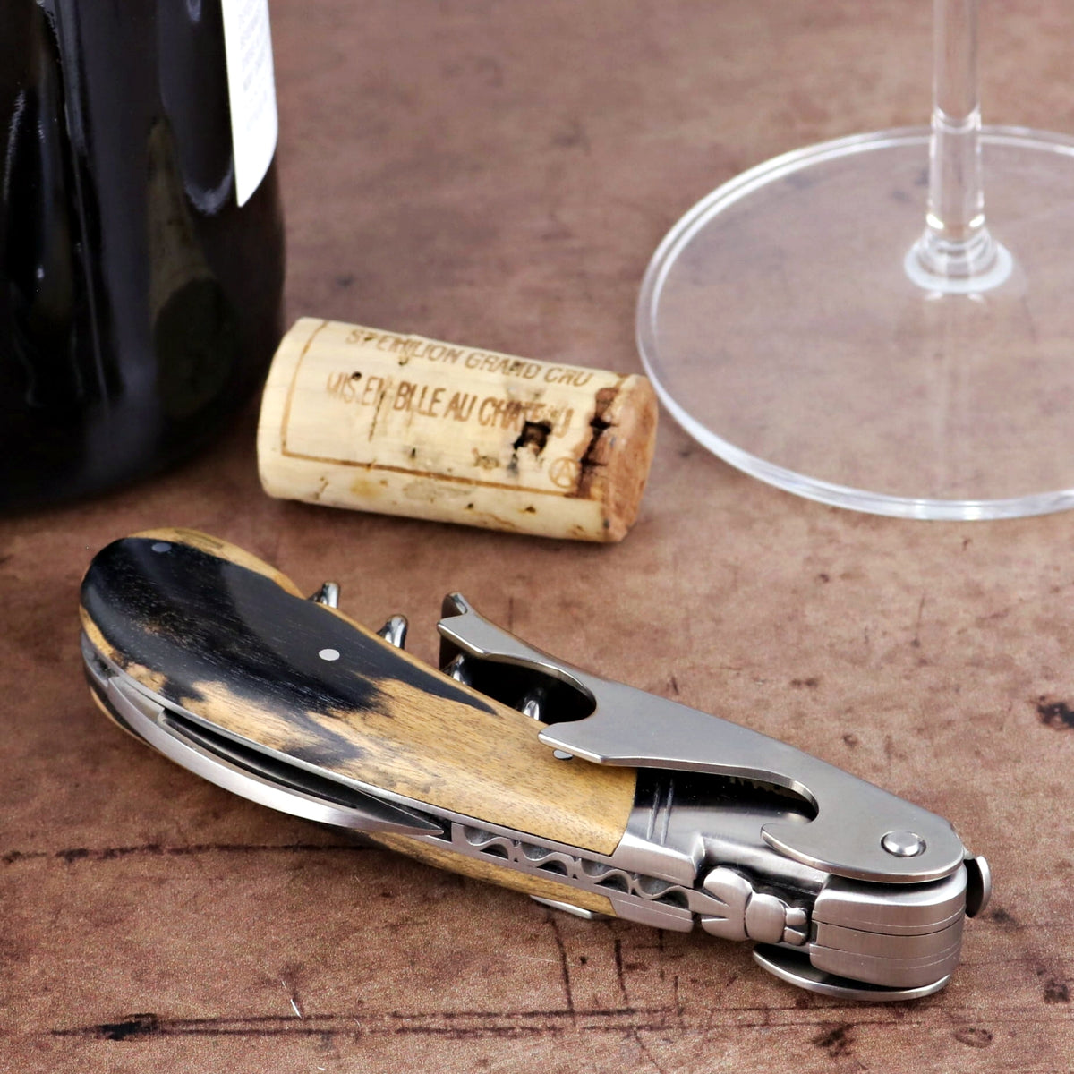 Laguiole Magnum Royal Ebony Corkscrew, close-up of ebony and wood handle, stainless steel mechanism.