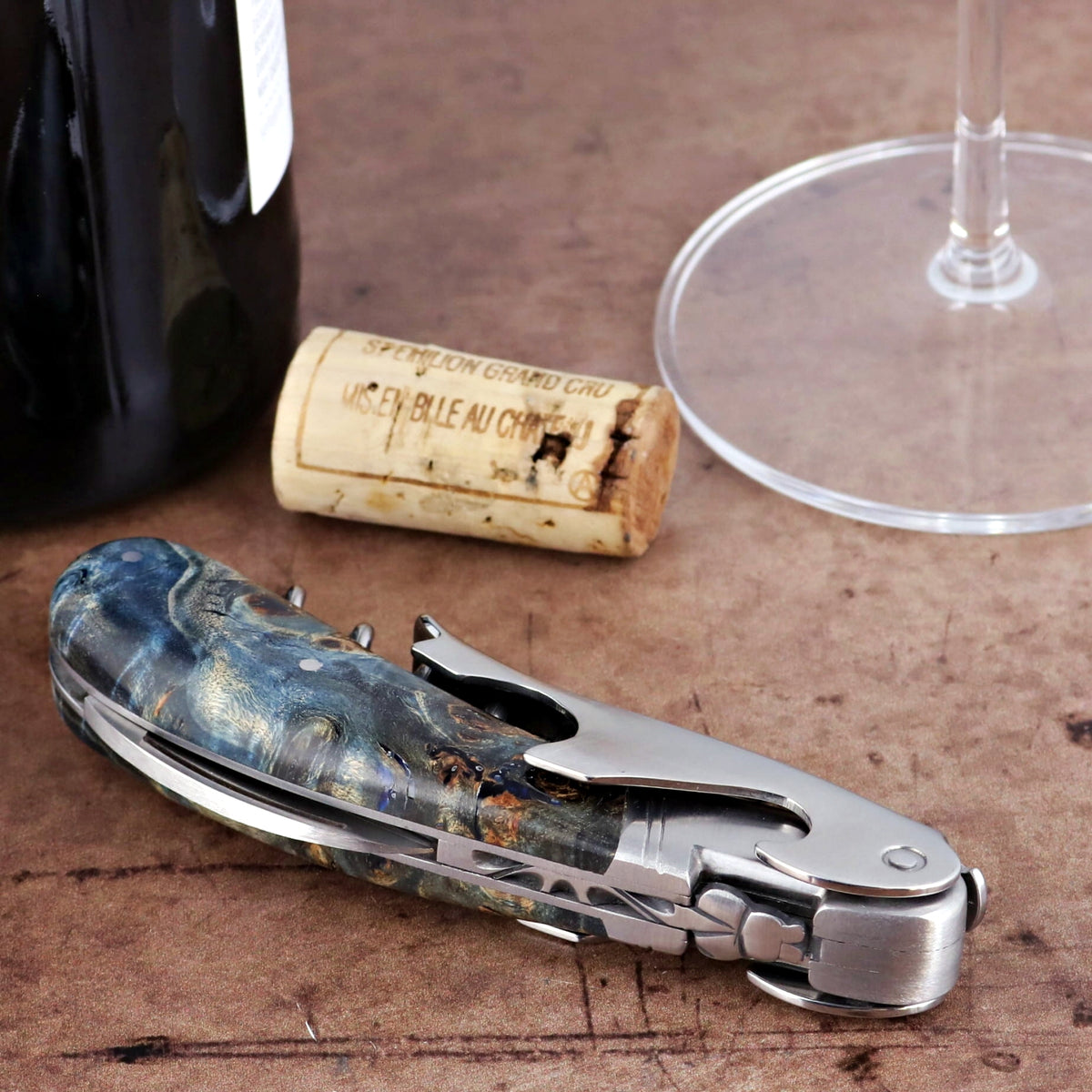 Laguiole Magnum Stained Poplar Burl Corkscrew Blue, close-up of blue burl handle and silver tools.