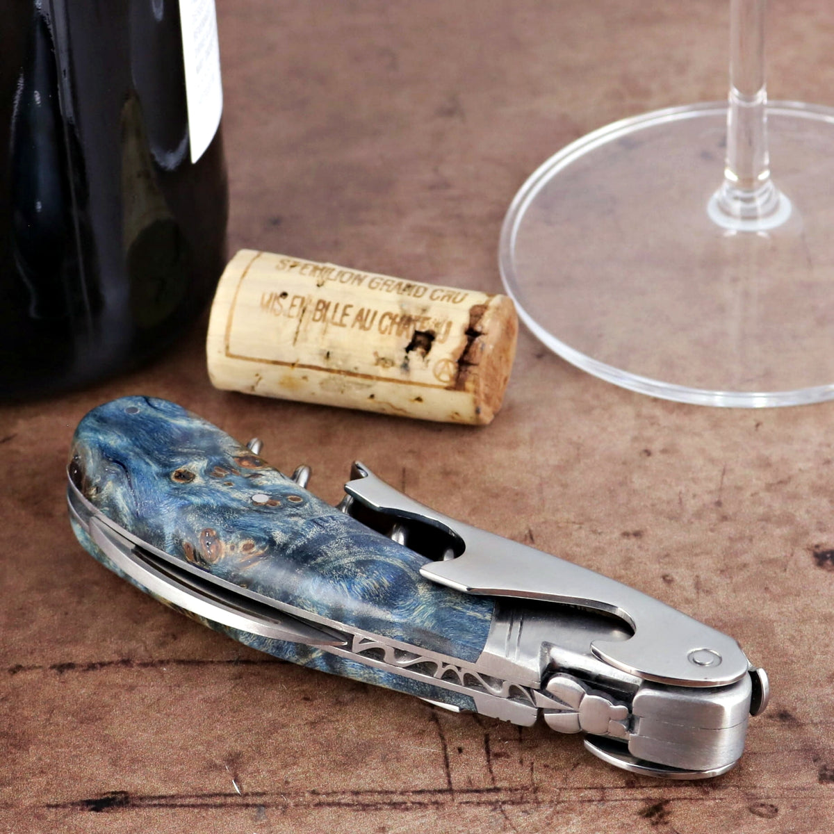 Laguiole Magnum Stained Poplar Burl Corkscrew Blue, close-up of blue burl handle and silver tools.