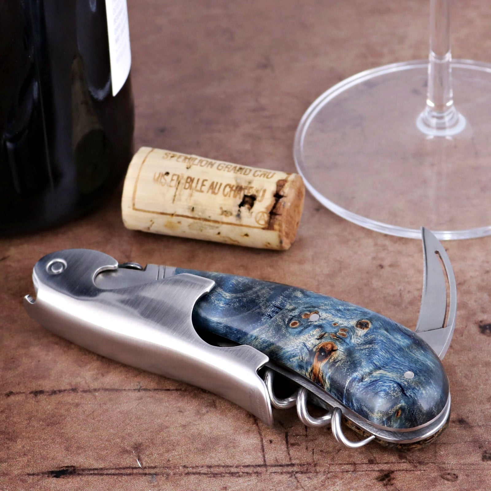 Laguiole Magnum Stained Poplar Burl Corkscrew Blue, side view, showing blue burl handle and metal body.