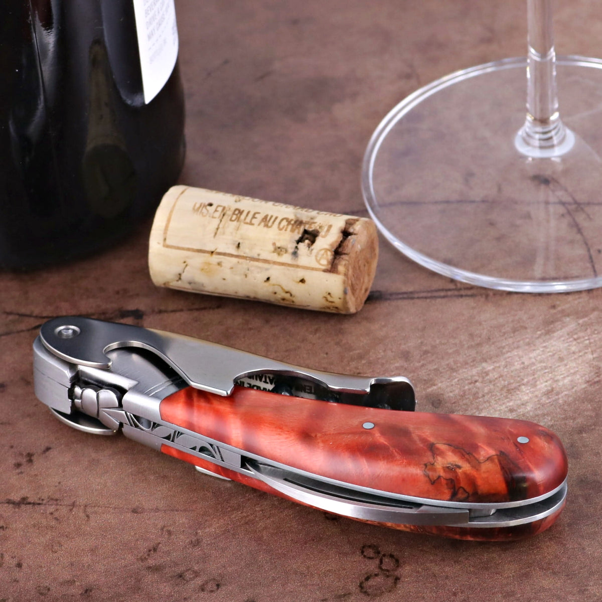 Laguiole Magnum Stained Poplar Burl Corkscrew Red, close-up of red burl handle and metal body.