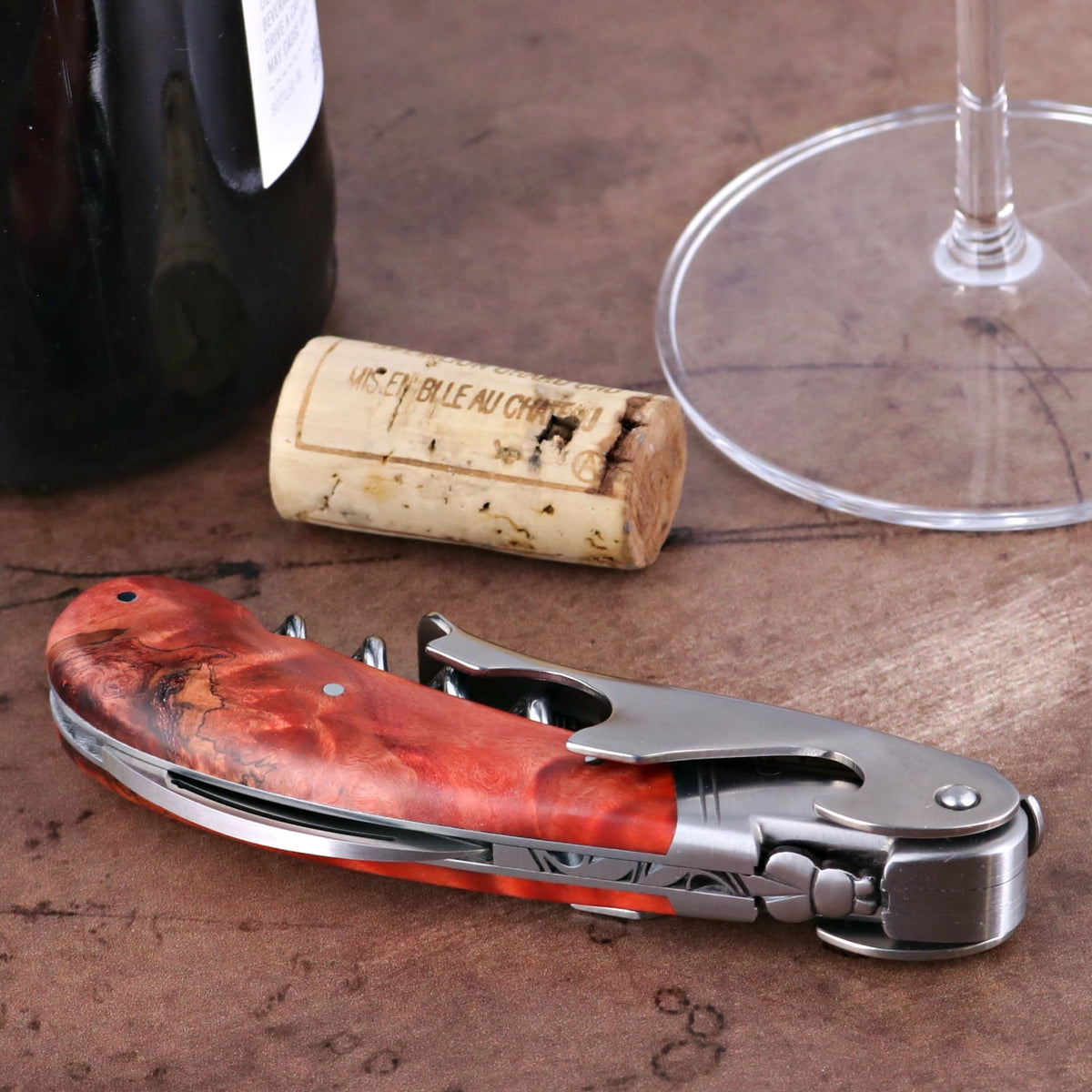Laguiole Magnum Stained Poplar Burl Corkscrew Red, close-up of the red burl handle and stainless steel tools.