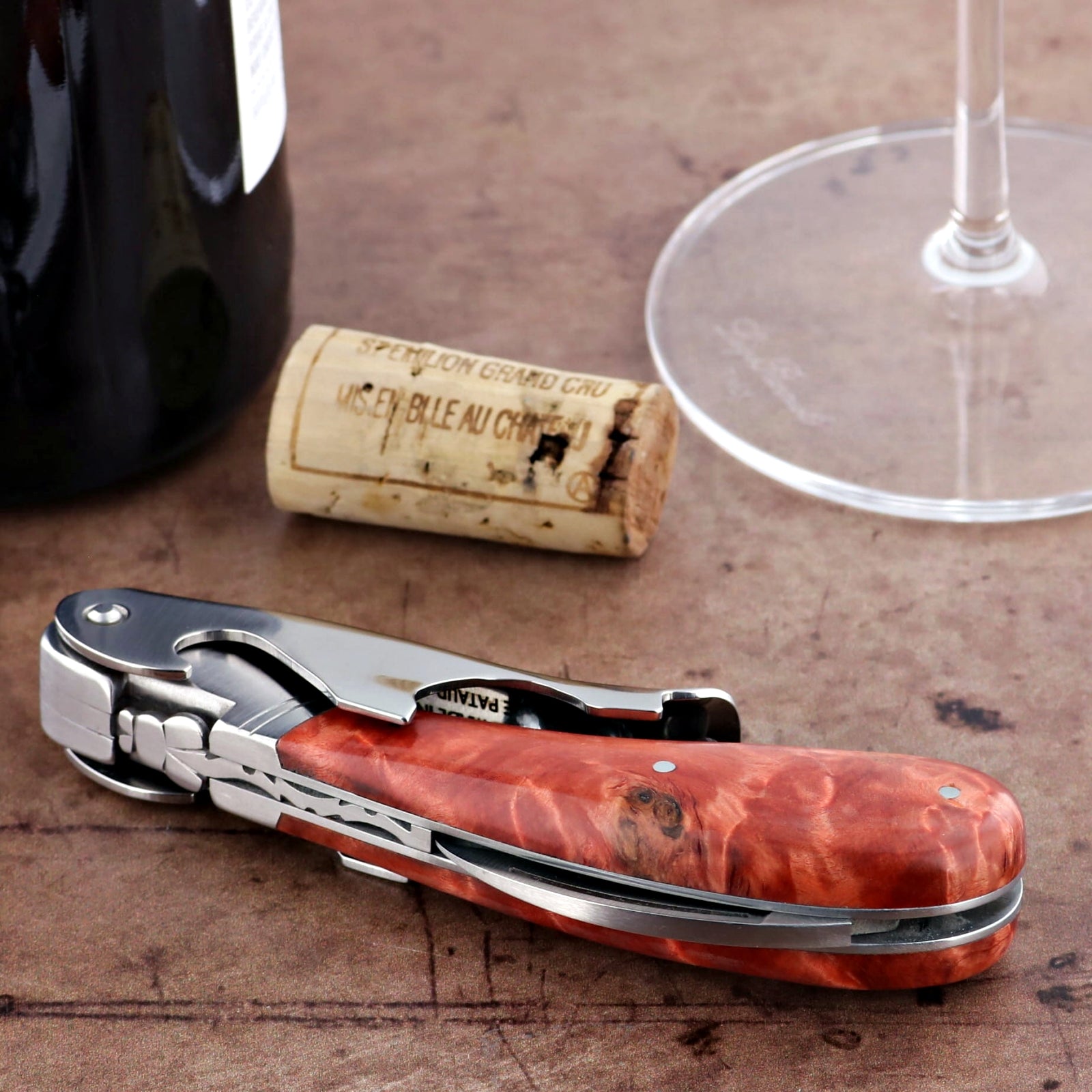 Laguiole Magnum Stained Poplar Burl Corkscrew Red - F, close-up of the red wood handle and silver body.