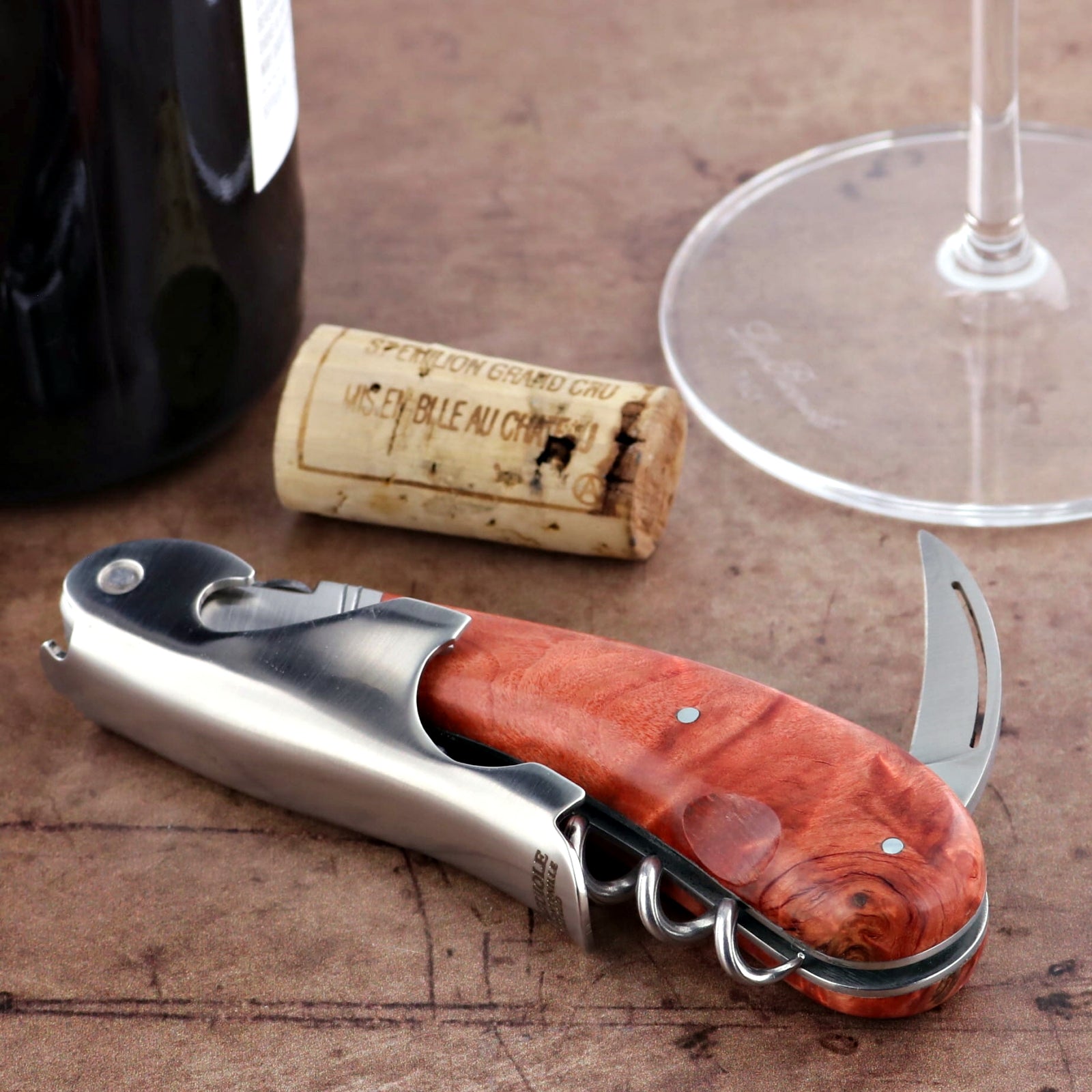 Laguiole Magnum Stained Poplar Burl Corkscrew Red - F, close-up of the red wood handle and silver body.