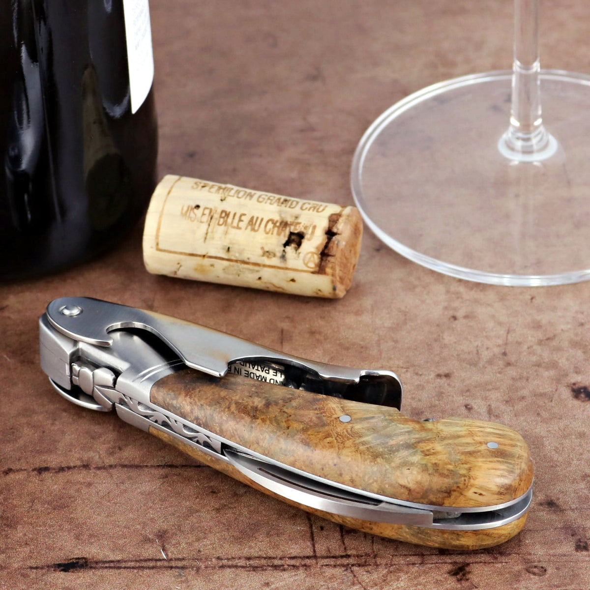 Laguiole Magnum Teak Corkscrew, close-up of the natural wood handle and polished steel.