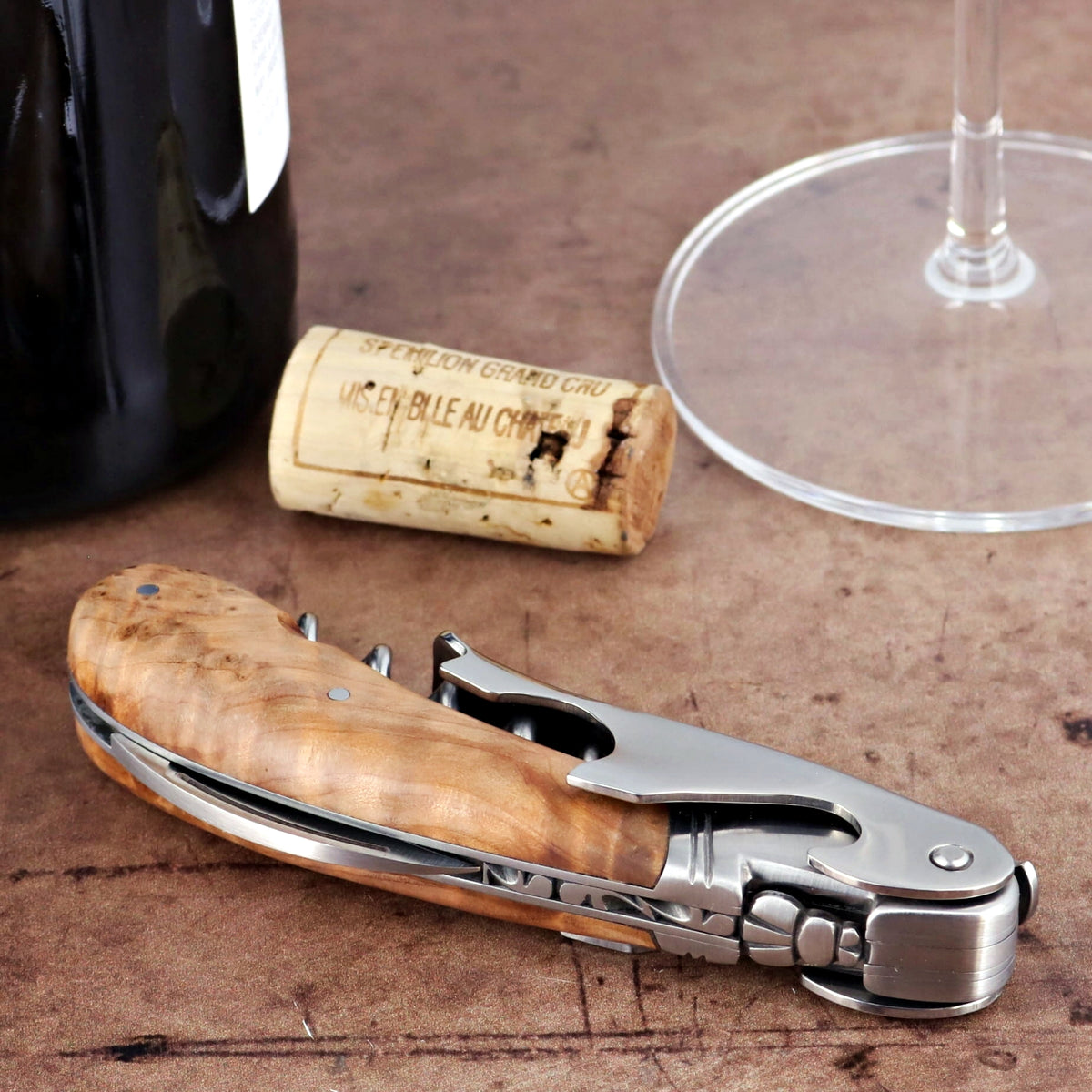Laguiole Magnum Thuya Burl Corkscrew, close-up of the wood handle and stainless steel tools.