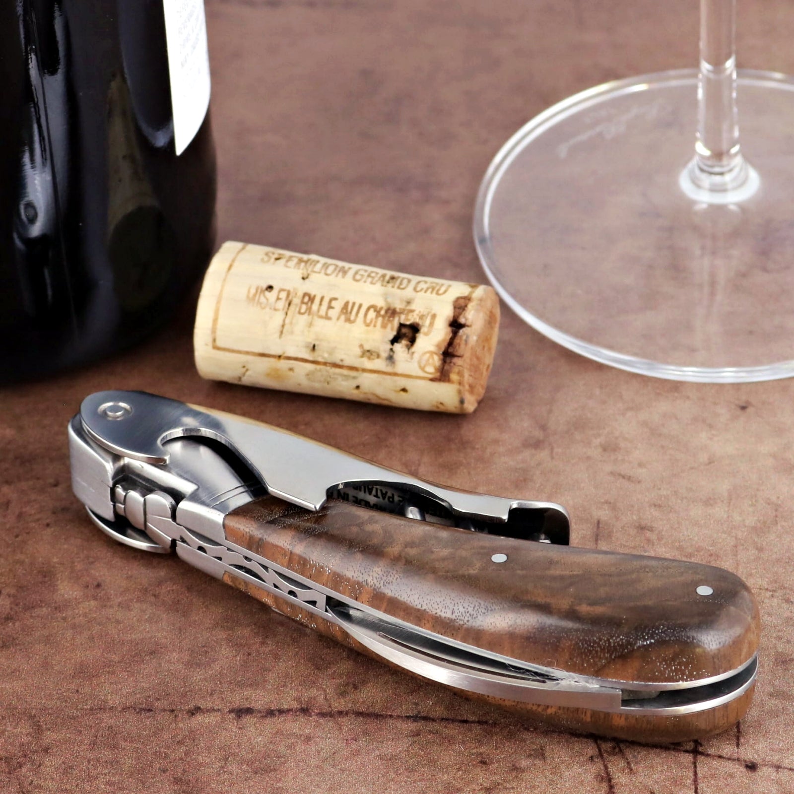Laguiole Magnum Walnut Corkscrew, close-up of its polished steel and rich walnut handle.
