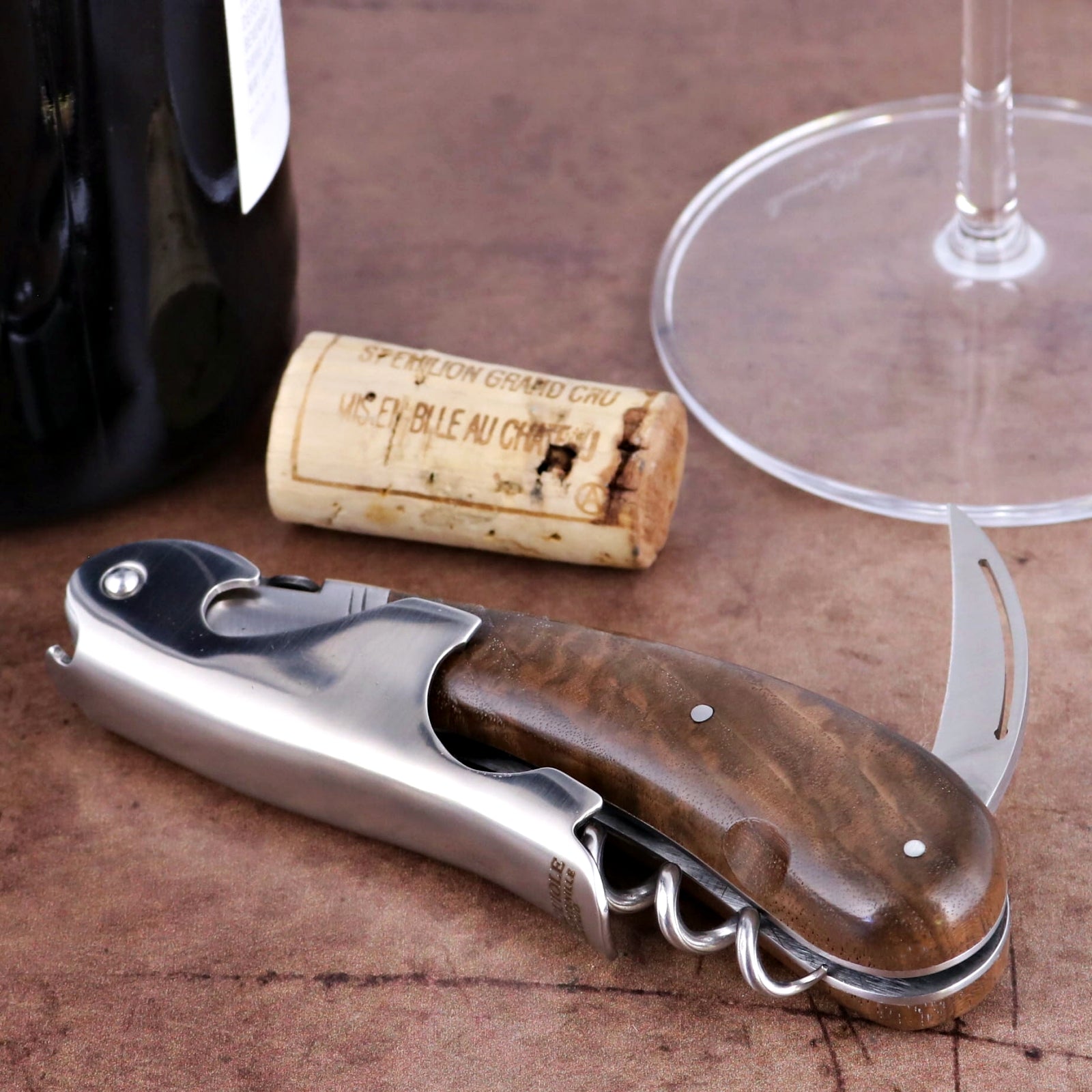Laguiole Magnum Walnut Corkscrew, close-up of its polished steel and rich walnut handle.