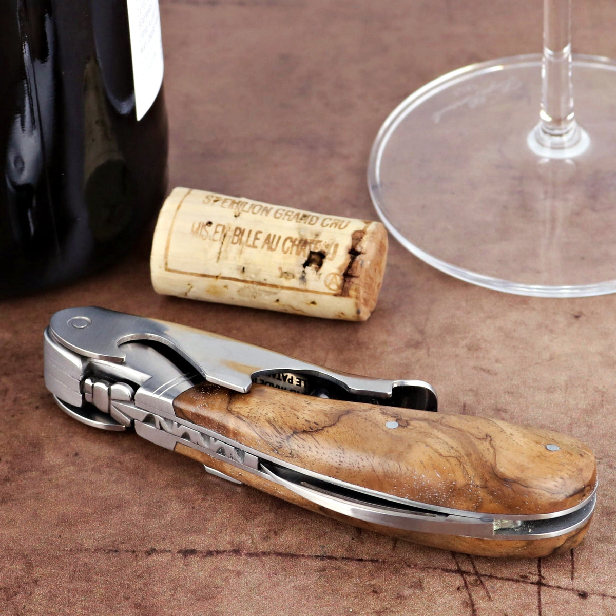 Laguiole Magnum Walnut Corkscrew, close-up of its polished stainless steel and natural walnut handle.