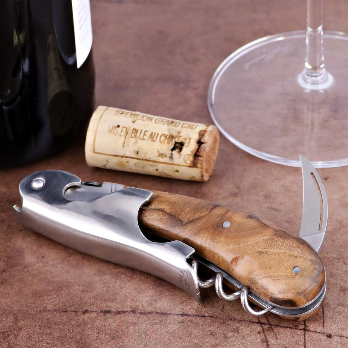 Laguiole Magnum Walnut Corkscrew, close-up of walnut handle, stainless steel body, and foil cutter.