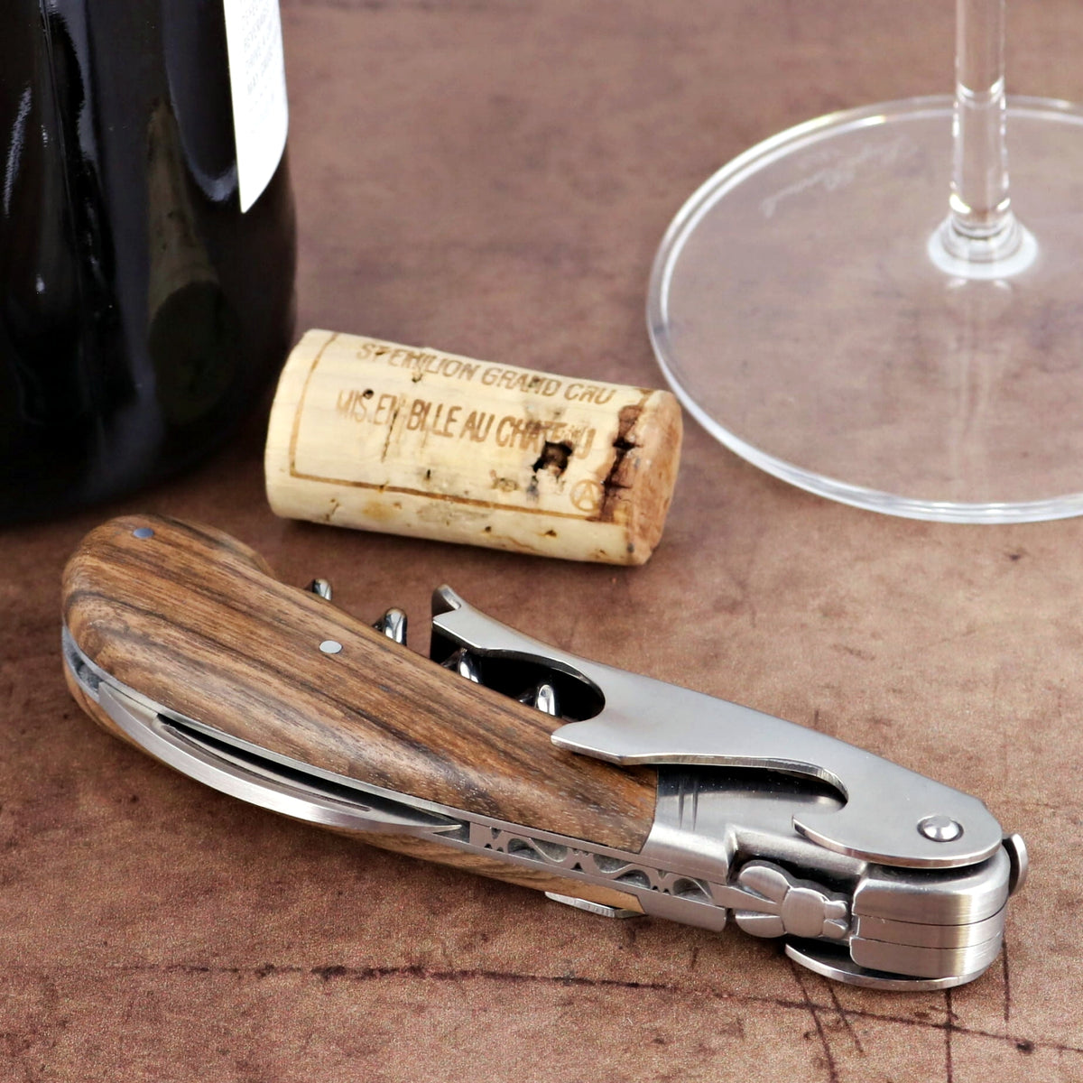 Laguiole Magnum Walnut Corkscrew, close-up of wood handle and silver metal tools.