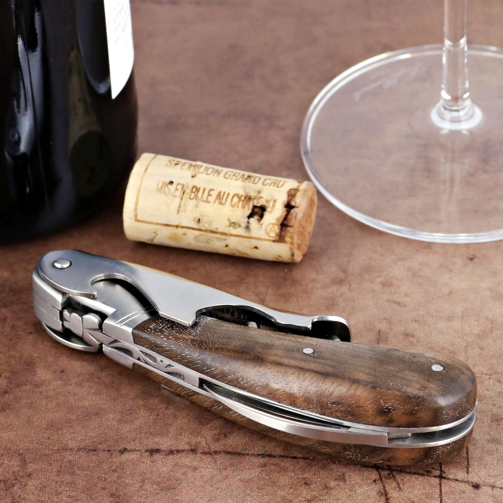 Laguiole Magnum Walnut Corkscrew, close-up of its polished steel and rich walnut handle.