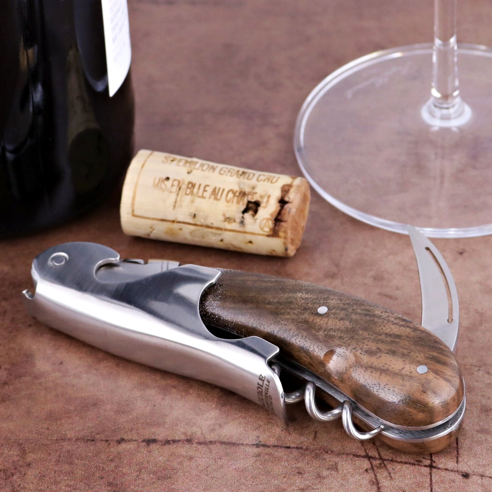 Laguiole Magnum Walnut Corkscrew, close-up of its polished steel and rich walnut handle.