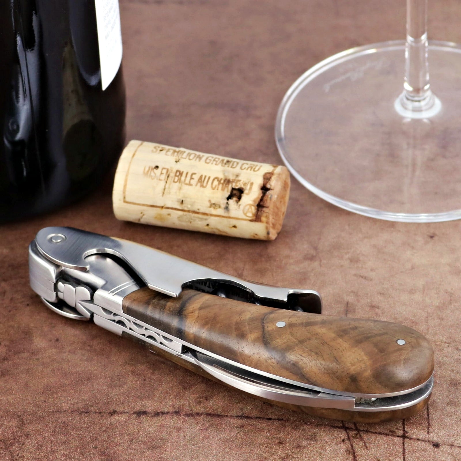 Laguiole Magnum Walnut Corkscrew, close-up of polished stainless steel and dark walnut handle.
