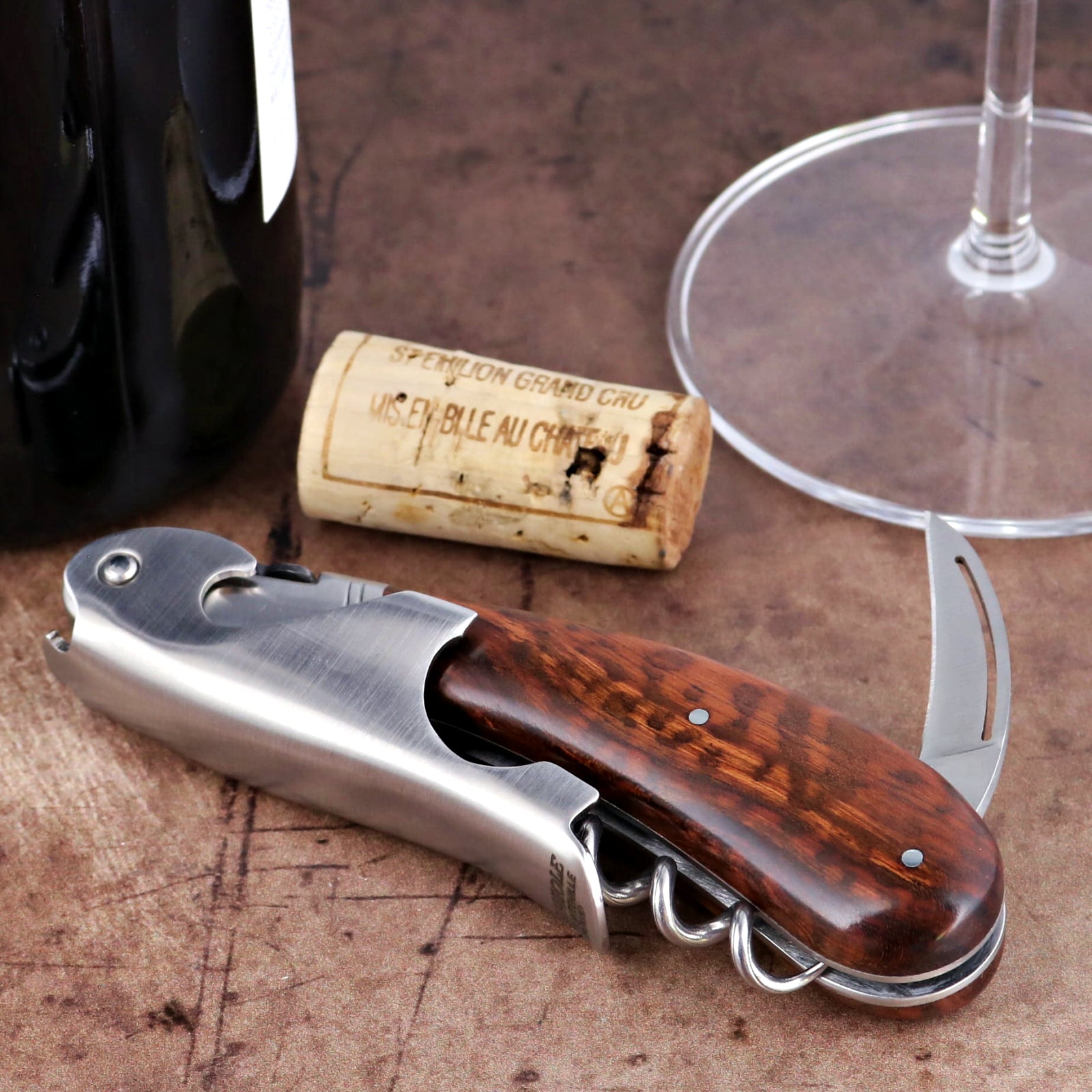Laguiole Magnum Amourette corkscrew close-up featuring a polished steel body and rich wood handle.