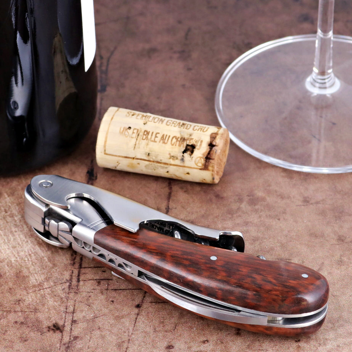 Laguiole Magnum Amourette Corkscrew close-up featuring a polished steel body and rich wood handle.
