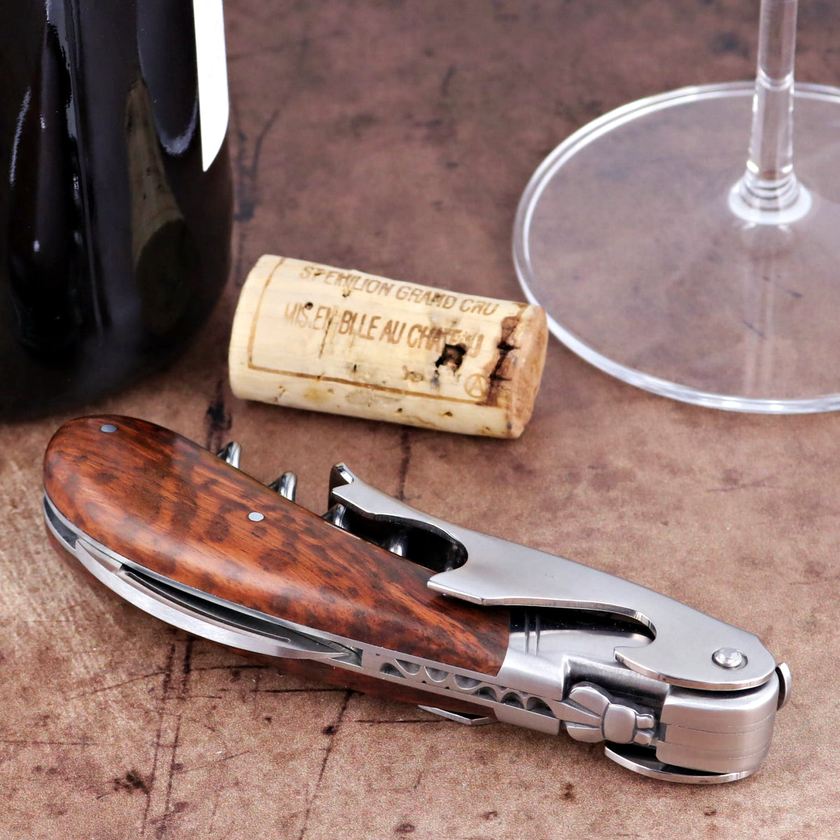 Laguiole Magnum Amourette Corkscrew, close-up of polished steel and rich, grained wood handle.