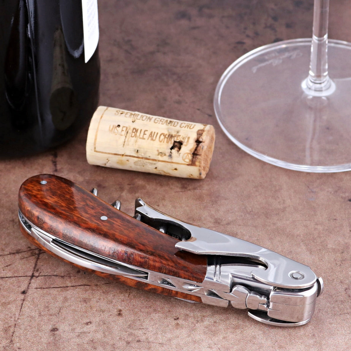 Laguiole Magnum Amourette Corkscrew, close-up side view of polished steel and rich wood grain handle.