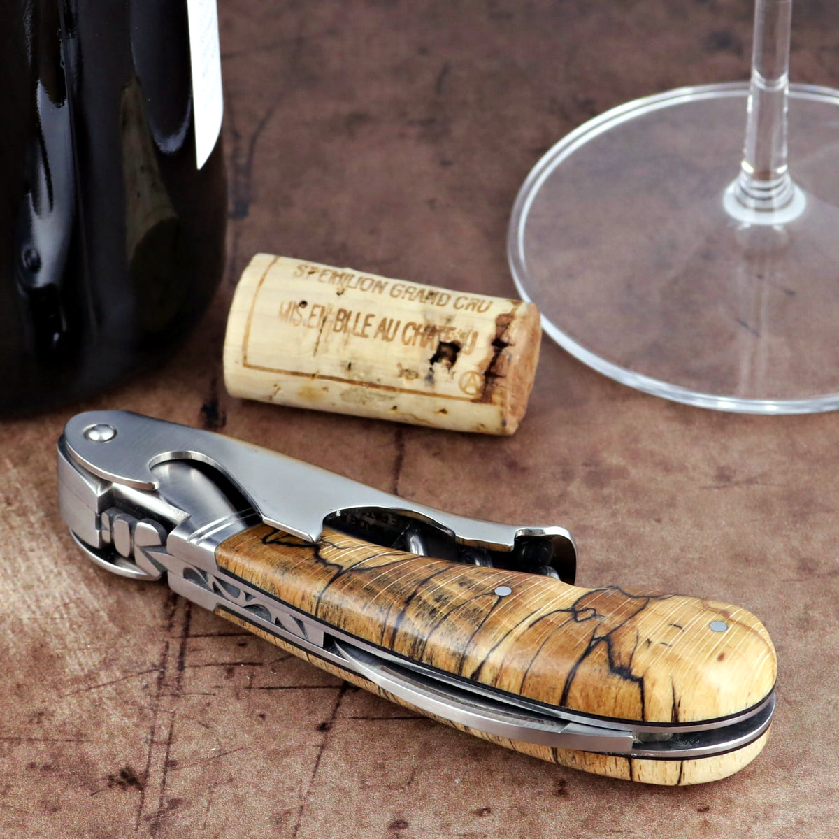 Laguiole Magnum Burled Beech Corkscrew, close-up side view showing the polished steel and wood grain.