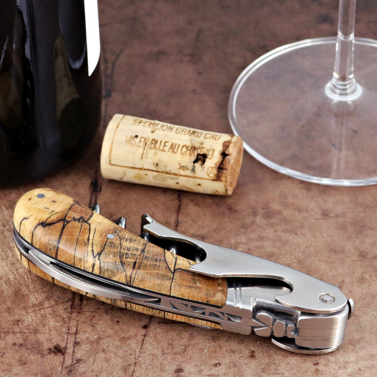 Laguiole Magnum Burled Beech corkscrew, close-up of the polished steel and natural wood grain handle.
