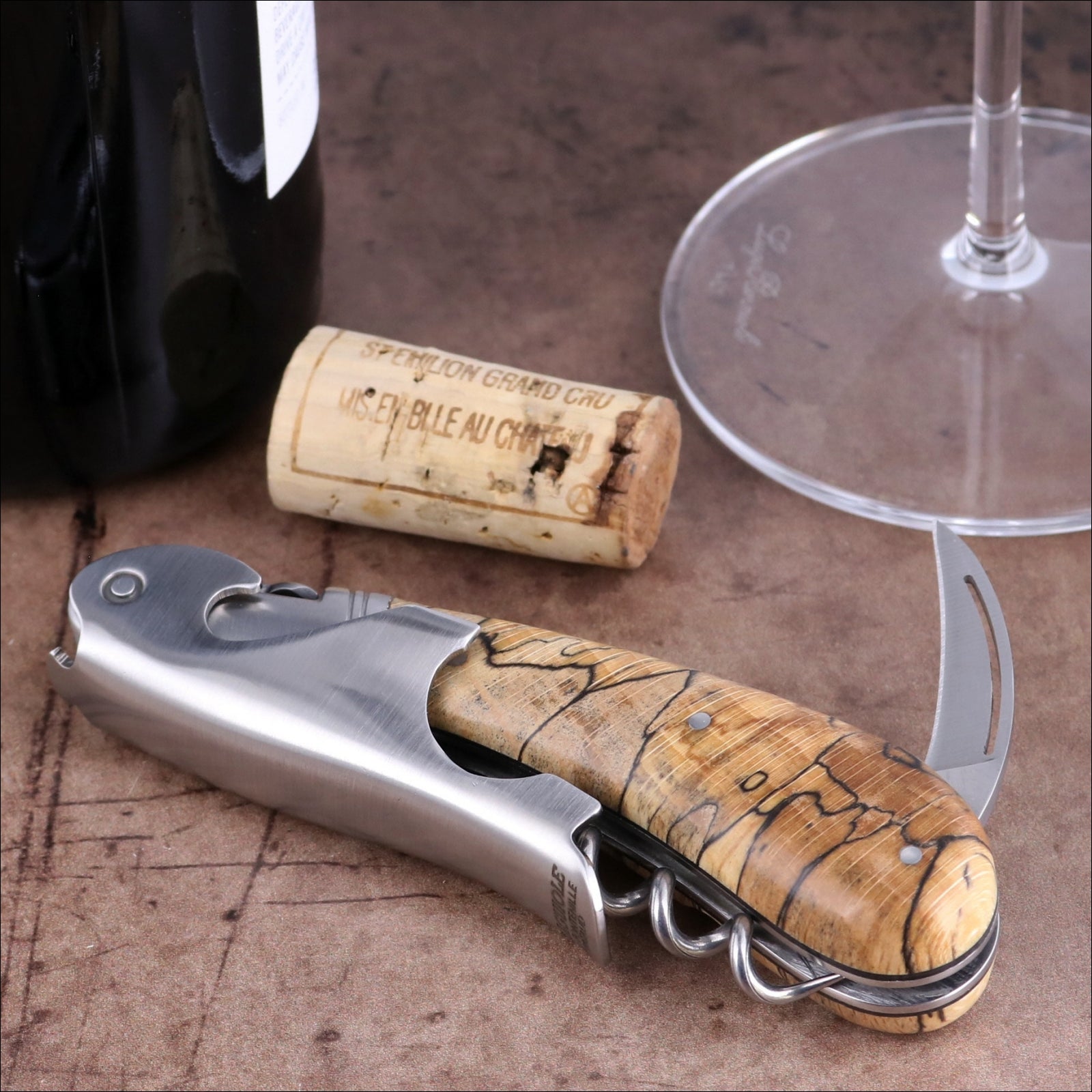 Laguiole Magnum Burled Beech Corkscrew, close-up of polished steel and natural wood handle detail.