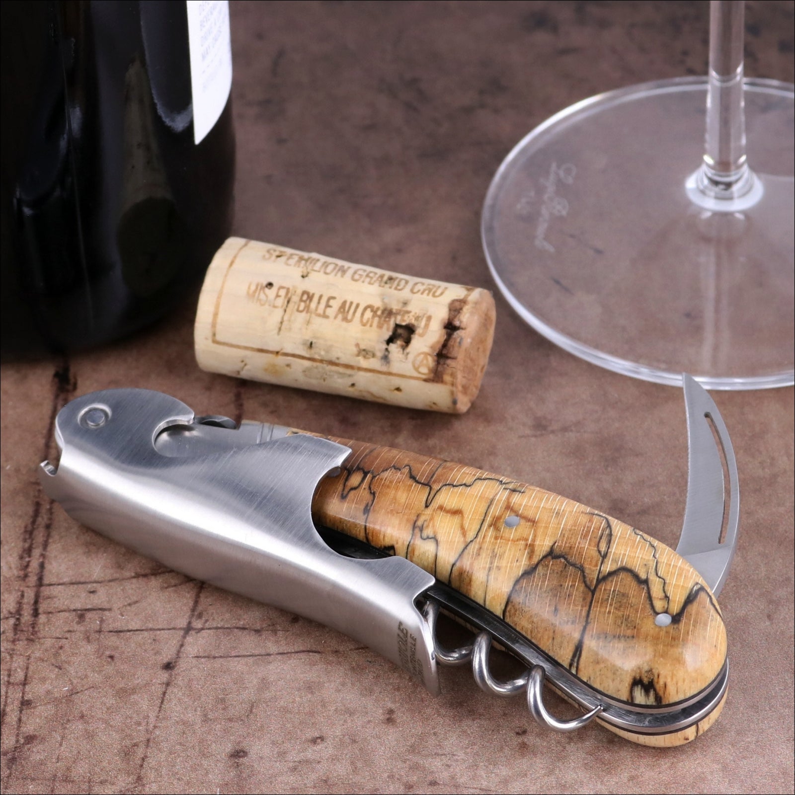 Laguiole Magnum Burled Beech Corkscrew, close-up of polished steel and natural wood grain handle.